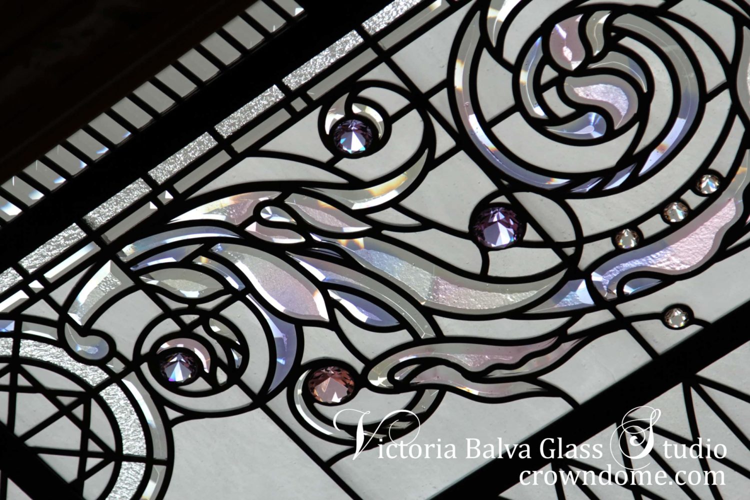 Stained and leaded glass dome skylight detail with ornamental border made of hand beveled glass with a delicate color stretching of pale pink, lilac and pale yellow