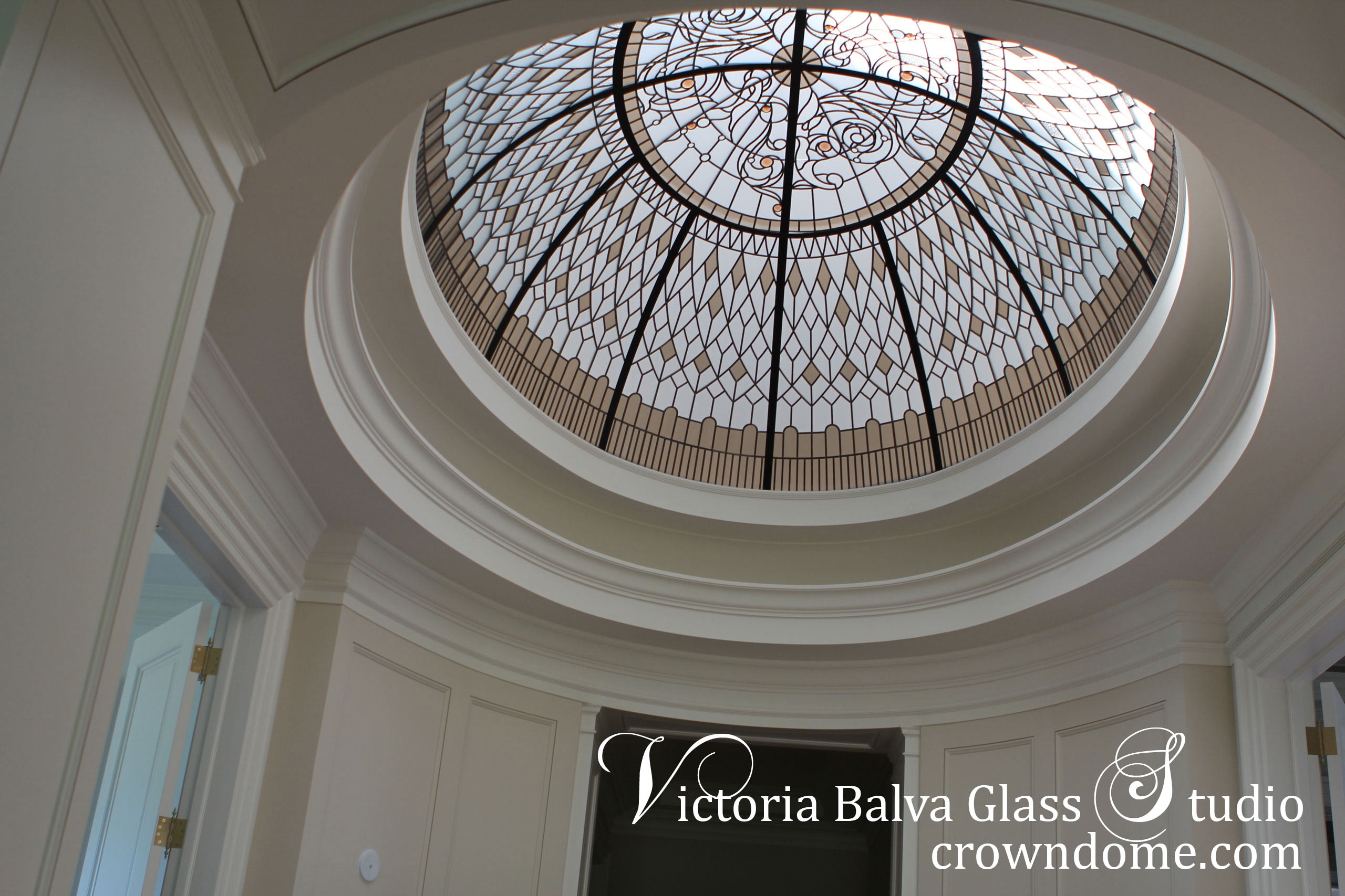 Large oval stained leaded glass dome skylight for an oval hallway of a custom built house in Toronto. Large oval stained leaded glass dome ceiling masterpiece with bronze textured glass and colored jewels