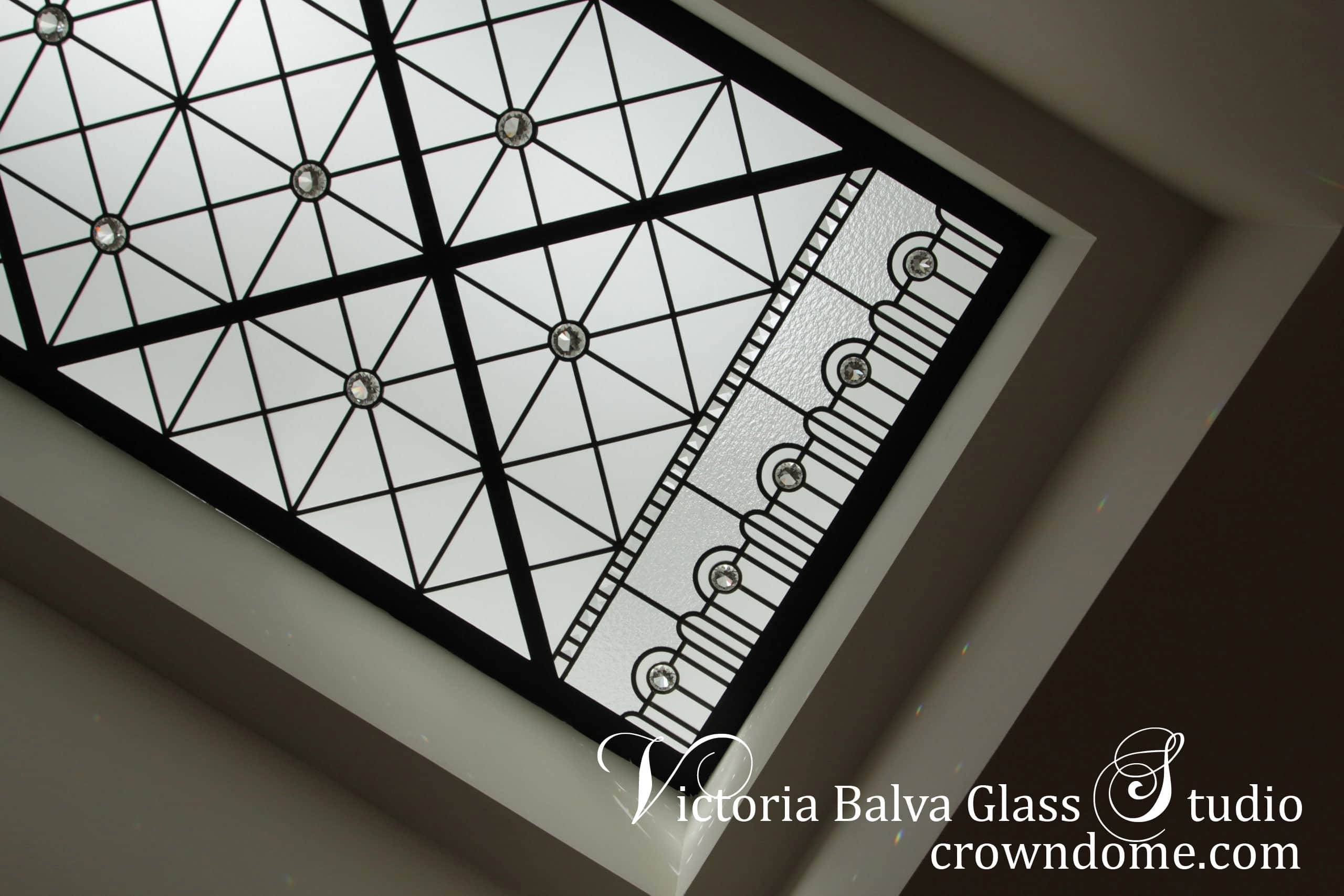 Simple geometric stained leaded glass skylight ceiling for a hallway of a luxury custom built residence with clear textured glasses, beveled glass and clear crystal jewels as accents. The contemporary minimal styling of the glass ceiling design brings modern feeling into space with a reference to a classic design reflecting a modern lifestyle of the residents. Leaded glass skylight design by stained glass artist Victoria Balva