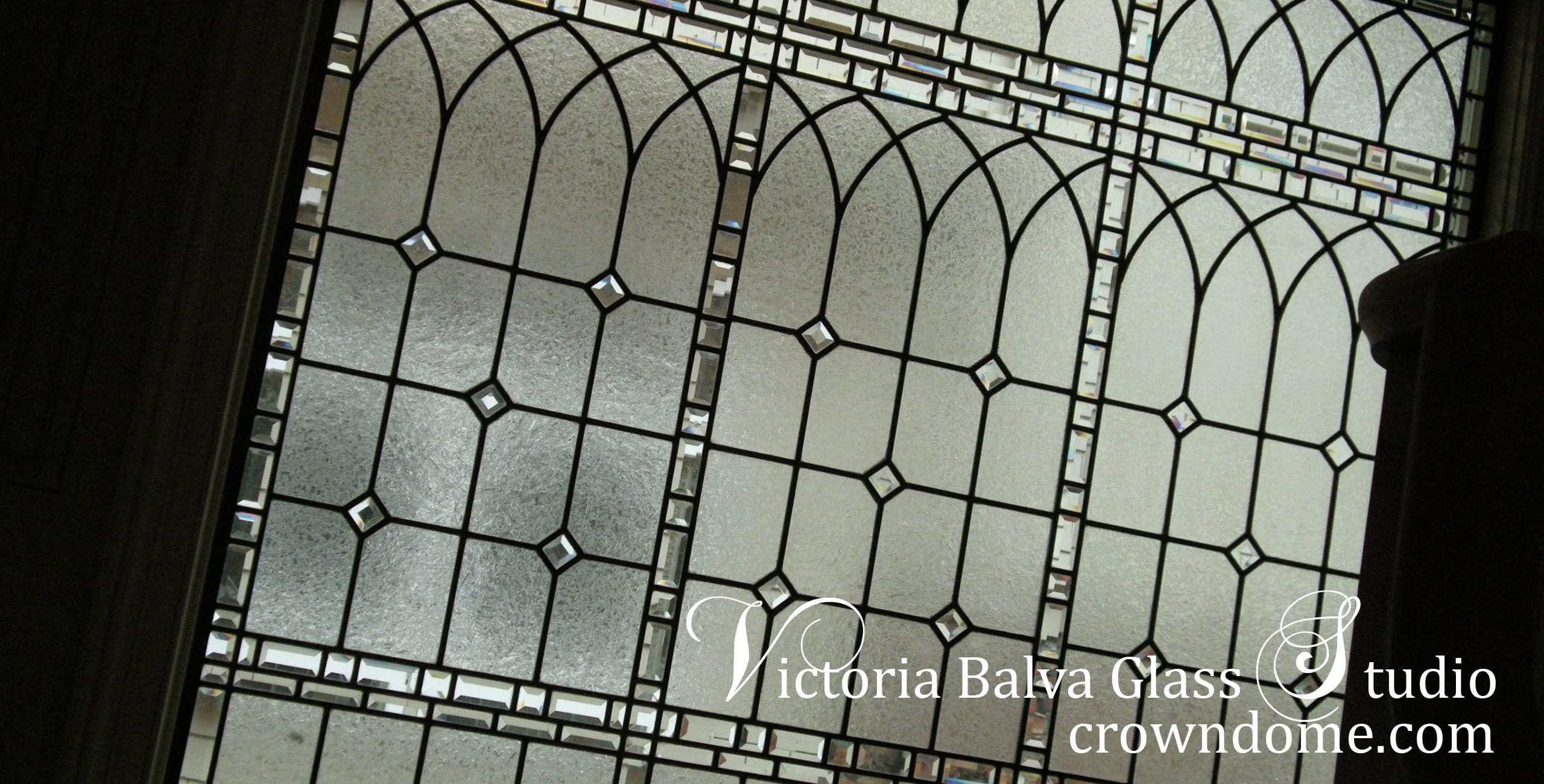 Traditional stained leaded glass window Old English Charm inspired by historical English Castles for a stairwell of a luxury custom built residence in Toronto. Simple classic design with clear textured glass and beveled glass. Stained leaded glass window design by stained glass artist Victoria Balva