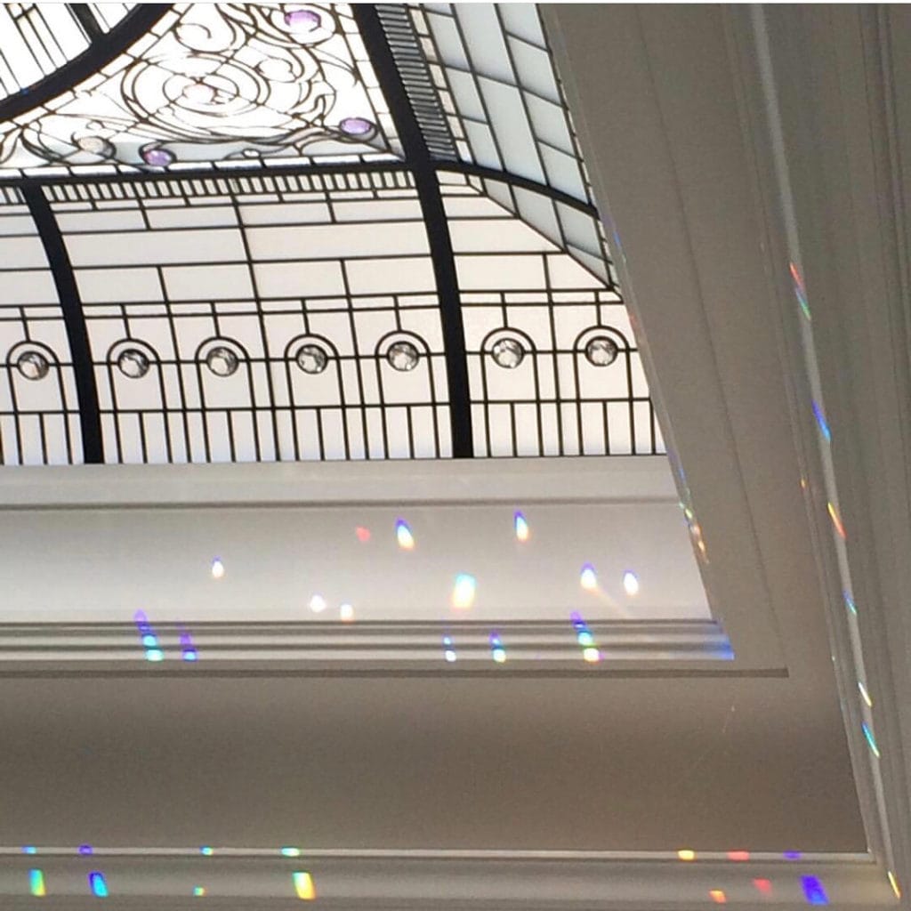 Afternoon sun dropping prisms of light from a stained glass domed ceiling in Toronto home. Interior design by Elizabeth Metcalfe