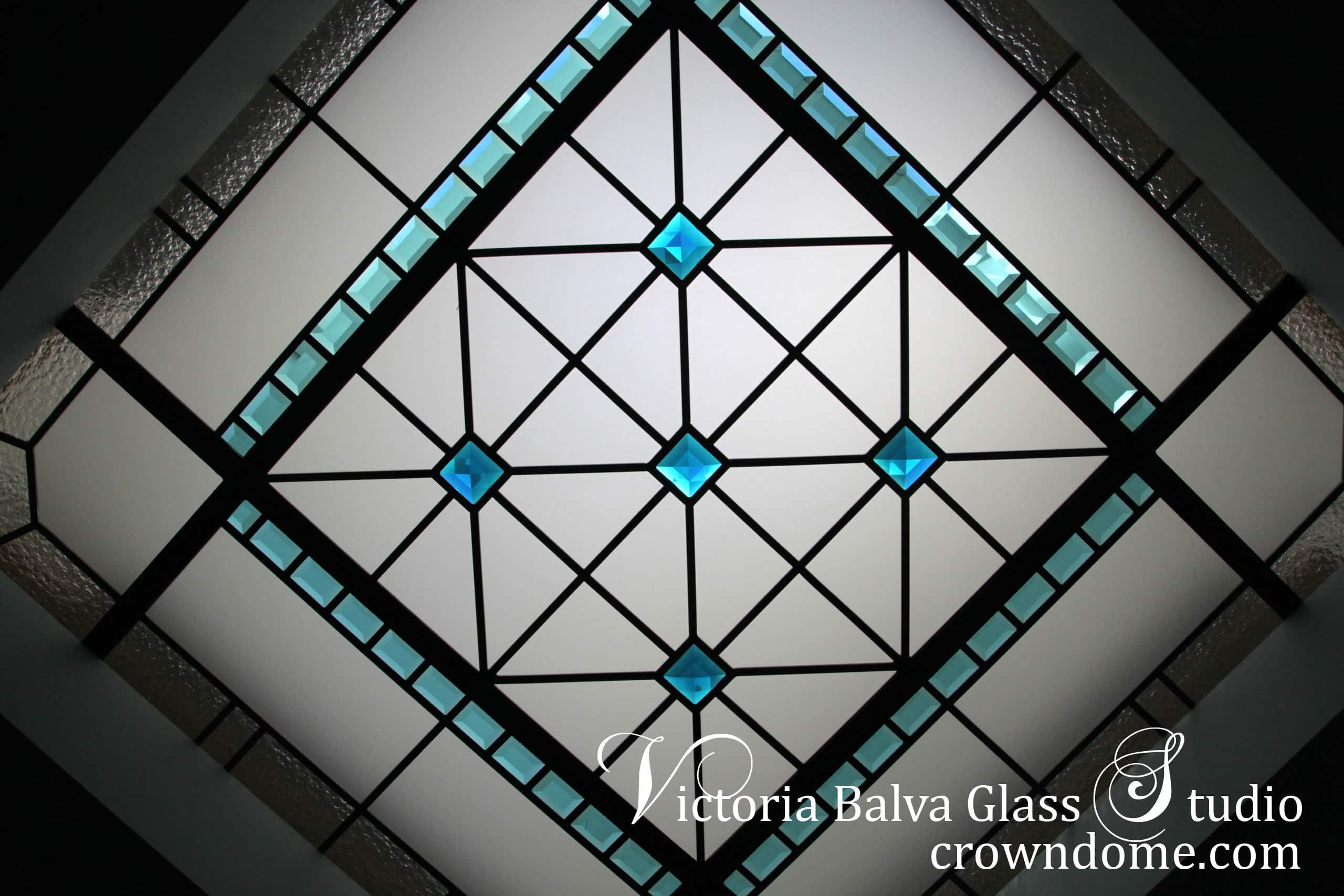 Octagon stained leaded glass skylight ceiling for a hallway of custom built residence in Waterloo. Accent turquoise crystal jewels, colored beveled glass with clear textured glasses highlight a modern style of the house. Combining classical elements and modern technologies and materials to achieve a new perception of the stained and leaded glass of 21 century. Stained leaded glass skylight design by stained glass artist Victoria Balva