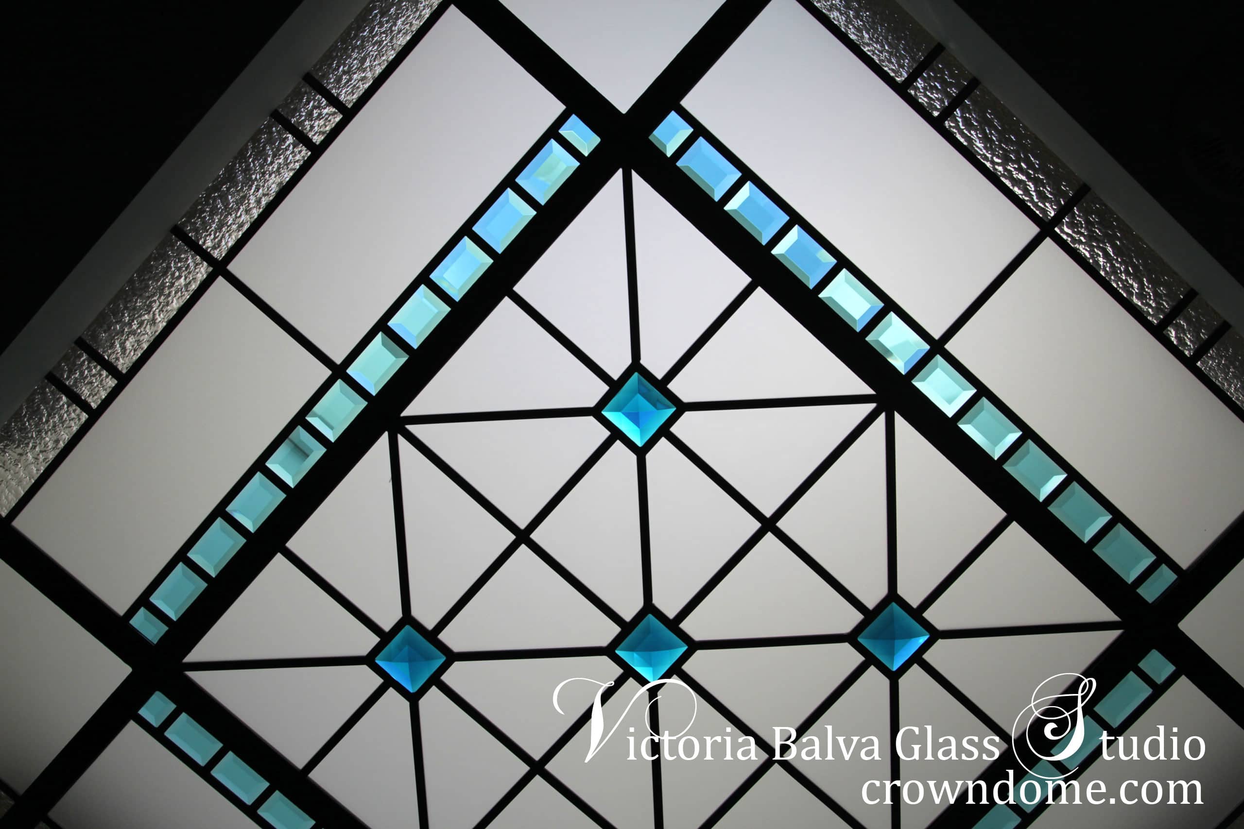 Contemporary octagon stained leaded glass skylight ceiling for a hallway of custom built residence in Waterloo. Accent turquoise crystal jewels, colored beveled glass with clear textured glasses highlight a modern style of the house. Combining classical elements and modern technologies and materials to achieve a new perception of the stained and leaded glass of 21 century. Stained leaded glass skylight design by stained glass artist Victoria Balva
